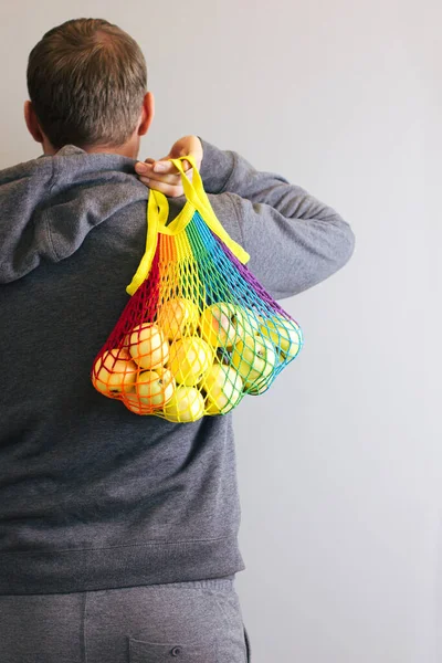 Man Holds His Hands Reusable Cotton Shopping String Bag Multicolored — Stock Photo, Image