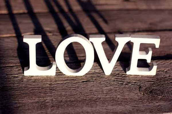 Word Love Made White Letters Brown Wooden Background Valentine Day — стоковое фото