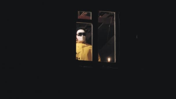 Homem estranho em uma máscara de robô aparece de repente na janela de uma casa velha — Vídeo de Stock