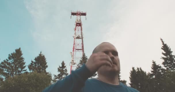 Torre de radio celular 4G y 5G, el hombre tiene un mal dolor de cabeza — Vídeo de stock