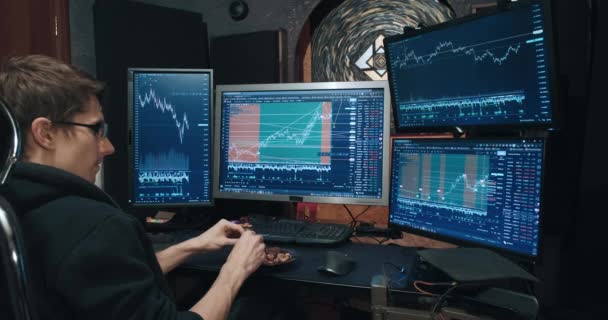 Male trader, freelancer on stock exchange trades options and eats nuts — Stock Video
