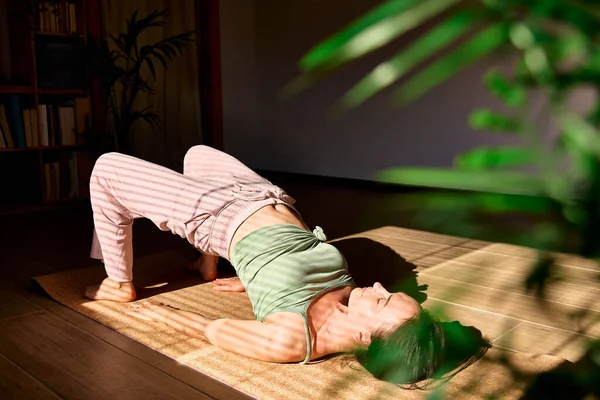 Kobieta Praktykująca Jogę Medytację Domu Siedząca Macie Jogi Rozciągająca Mięśnie — Zdjęcie stockowe