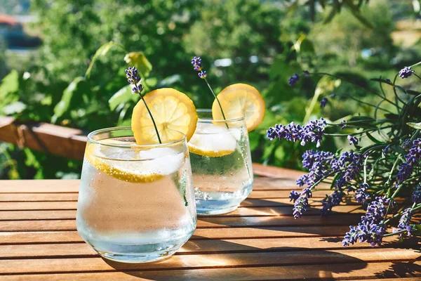 Cool lavender homemade lemonade with lemon slices and lavender flower. Healthy organic summer soda drink. Detox water. Diet unalcolic coctail.