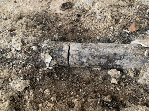 Scratched Lead Pipe Embedded Ground Obrazek Stockowy