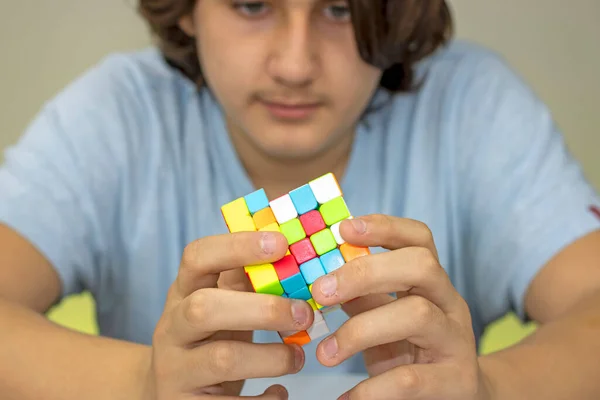 Teen turning a magic cube