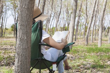 Kadın kırsalda piknik yapıyor. Mutlu, sıcak bir gün, açık havada. Parktaki kadın..
