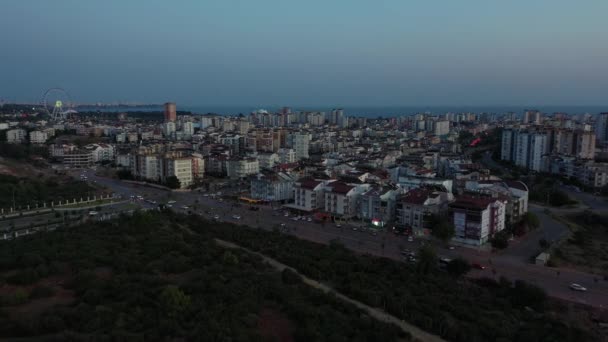 Aerial view of cityscape of modern coastal turkish city in the evening. — Stock Video