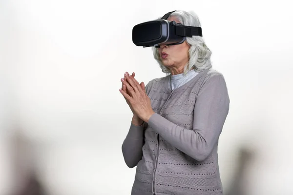 Vieja mujer caucásica con gafas de realidad virtual. — Foto de Stock