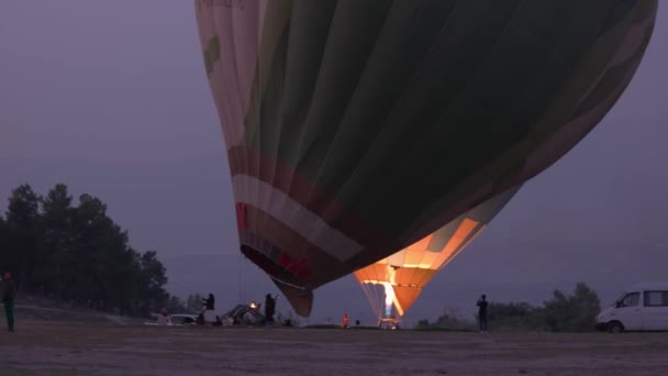 People heating the cold air inside the balloon using a large gas flame. — Stockvideo