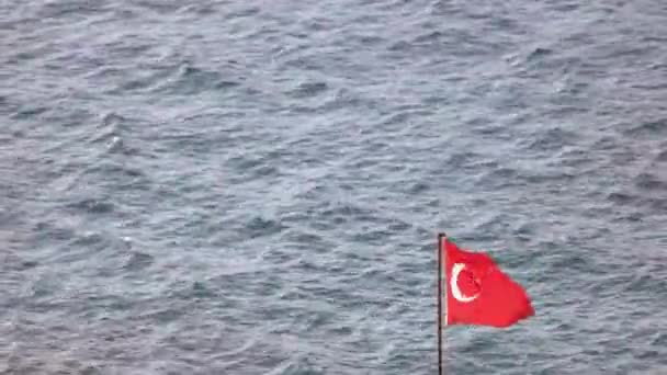 Flag of Turkey waving on wind on blue sea. — Stockvideo