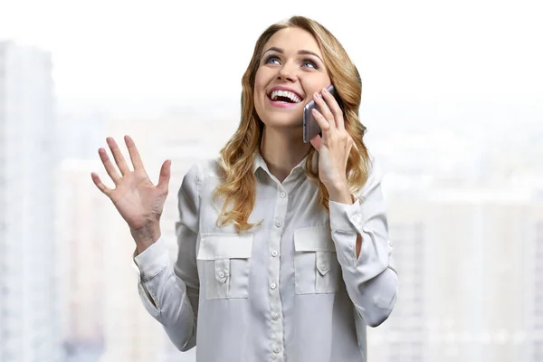 Radostná mladá žena ve formální halence mluví na mobilním telefonu. — Stock fotografie