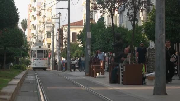 Running tram and walking people on the city street. City life concept. — Stock Video