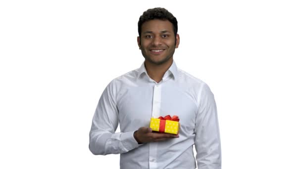 Positive young man showing gift box. — Stock Video