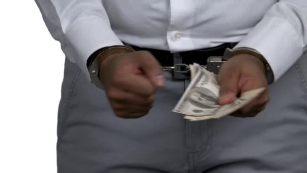 Man in handcuffs holding money close up. — Video