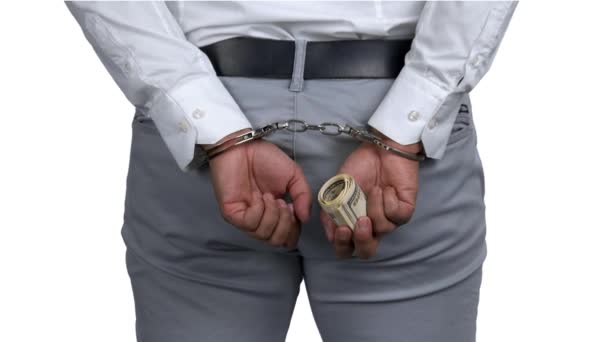 Close up male hands in handcuffs holding money. — Vídeos de Stock