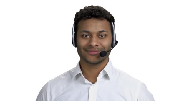 Young man with headset on white background. — Vídeo de stock