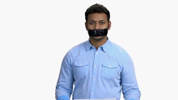 Indian man with taped mouth on white background — Vídeo de stock