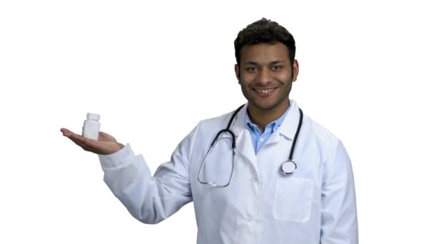 Male doctor showing pills on white background. — Stock Video