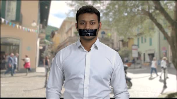 Young male protester with black tape over mouth. — Vídeos de Stock