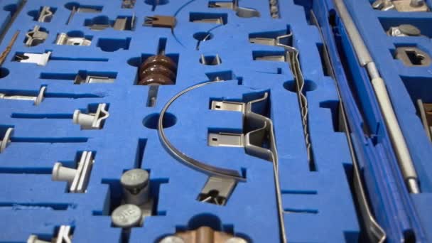 Set of metallic machine details in the blue foam rubber. — Stockvideo