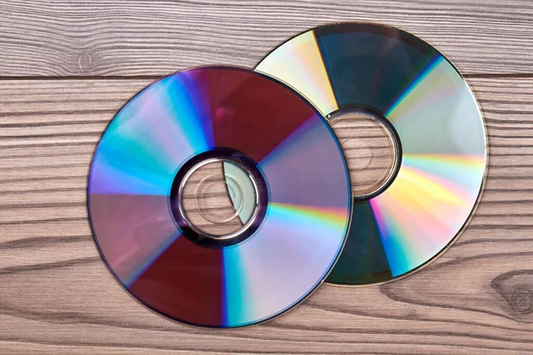 Pair of compact discs on a wooden background. — ストック写真