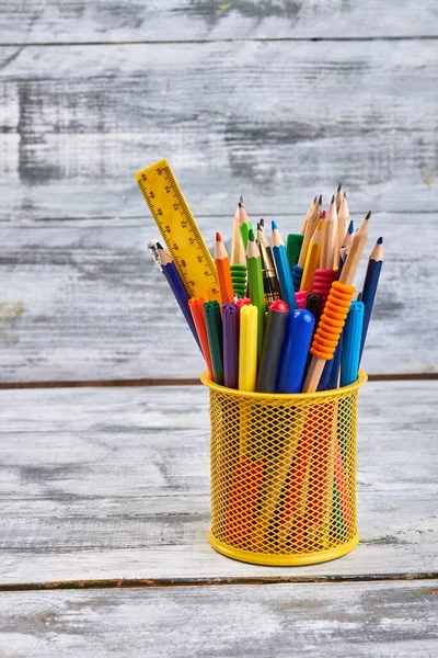 Vertical shot yellow holder with lots of pens and ruler. — Stok fotoğraf