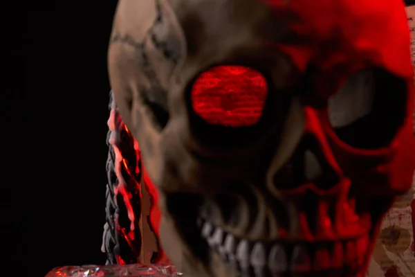 Close-up creepy humans skull with red lighting on black background. — Stock Photo, Image