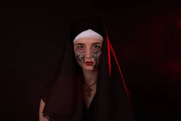 Portrait of a young girl in a hood with creepy face stained with candle wax. — Stock Photo, Image