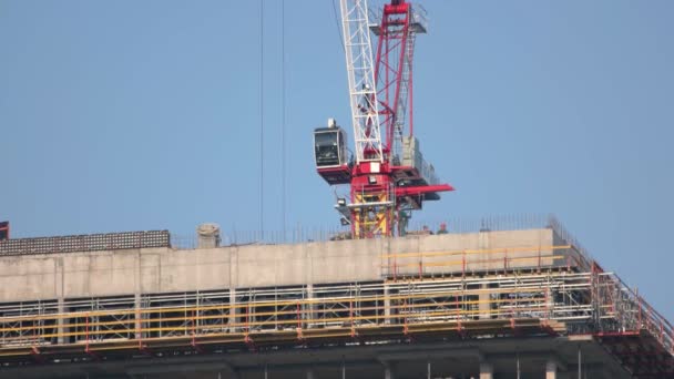 Gru e lavoratori in cima all'edificio di costruzione. — Video Stock