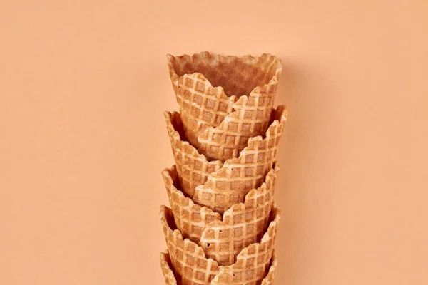 Delicious sweet ice-cream cones set on color background. Space for text.
