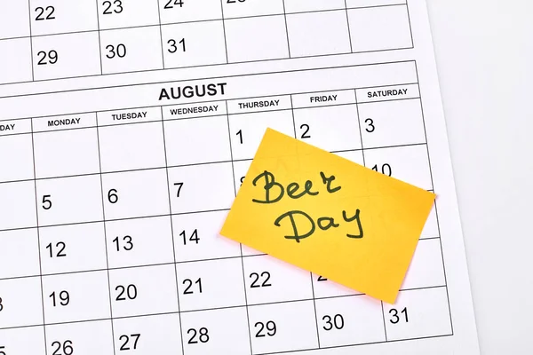 Beer day concept. August month calendar on white background. Holiday celebration top view.