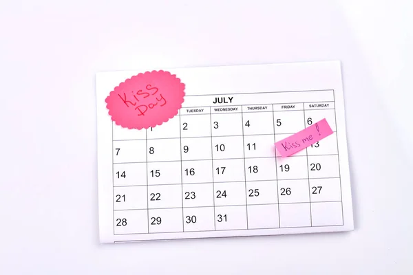 July calendar and kiss day celebration concept. Isolated on white background.