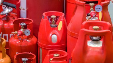 Storage of many various gas cylinders with propane. Red blue and orange ballons with gas.