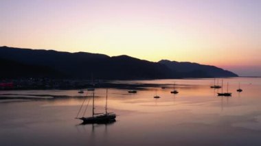 Beautiful sunset over Mediterranean sea. Sea bay with anchored boats. Vacation concept.
