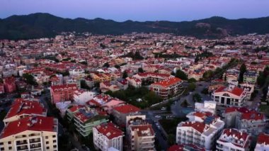Aerial drone view over red roof tiled buildings on the background of mountains. Beautiful european city from above. Go everywhere.
