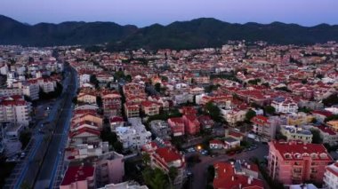 Aerial drone view of residential buildings and mountains in the background. Urban city in Europe.