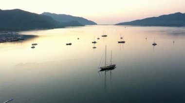 Scenic view of sea bay with boats and mountains in the background. Aerial island seascape.