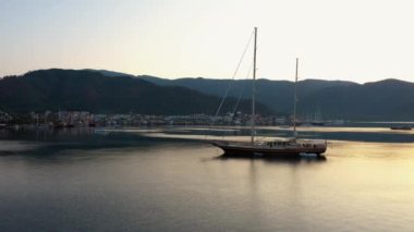 View of boats with beautiful city buildings and mountains at sunset. Sea bay at Marmaris, Turkey. Go everywhere.