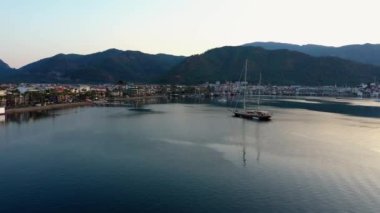 Aerial panoramic view of sea bay, city buildings and mountains. Vacation at Turkey.
