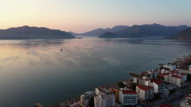 Aerial seascape with mediterranean sea bay and coastline of Marmaris city resort in Turkey. Urban and nature landscape at sunset. Go everywhere.