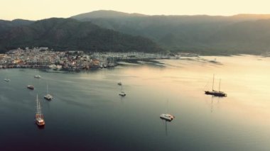 Aerial view of a marina with boats and mountains in the background. Beautiful morning scene. Port of Marmaris, Turkey.