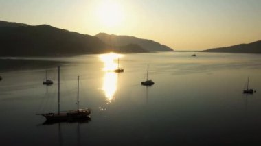 Aerial drone view of calm sea bay with parked boats. Beautiful morning scene on tropical island.