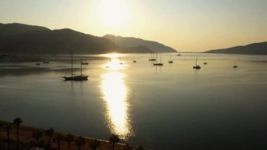 Seascape with boats on the background of mountains. Aerial panoramic view from drone. Nature landscape in the morning.