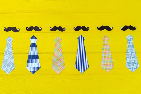 Set Stylish Mens Neckties Moustaches Yellow Wooden Desk — Stock Photo, Image