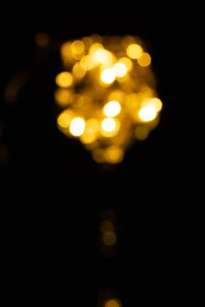 Out of focus fairy Light in a wine glass, in the Dark. — Stock Photo, Image