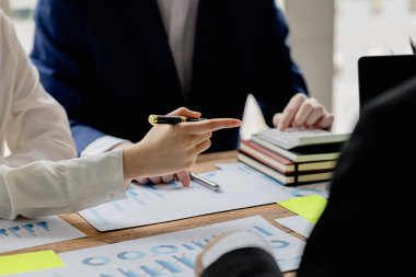Şirket konferans odasındaki bir masada, şirkete katılan ve destekleyen belgelerle birlikte şirketin büyümesini düzeltmek ve planlamak için beyin fırtınası yapan bir grup işadamı var. İş görüşmesi fikri.