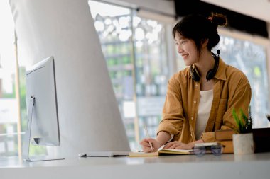 Beautiful Asian woman using a computer to study online, she is studying online. The concept of online learning due to the COVID-19 outbreak to prevent an outbreak in the classroom.