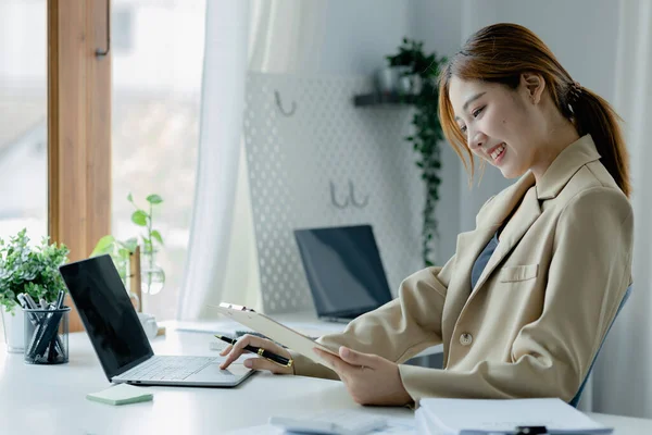 Asian women working in the office, young Asian business women as business executives, founding and running start-up executives, young female business leaders. Startup business concept.