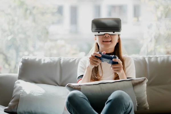Women wearing virtual reality glasses and game joystick to play games, using virtual reality technology to facilitate and enjoy relaxation, boundless imagination, Smartphone using with VR headsets.