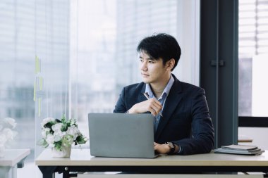 Asian man with suit, young businessman as startup company CEO, executive room, young startup company executives, run by young leaders. Management concept of startup companies and business men.